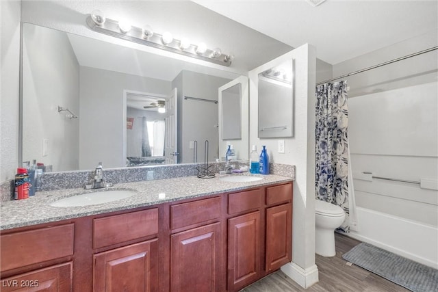 full bathroom with shower / bath combo with shower curtain, hardwood / wood-style floors, toilet, and vanity