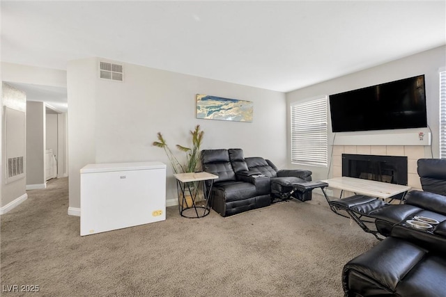 living room with light carpet and a fireplace