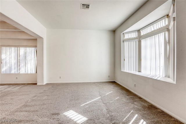 carpeted empty room featuring plenty of natural light