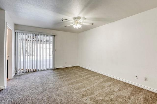 carpeted spare room featuring ceiling fan and a textured ceiling