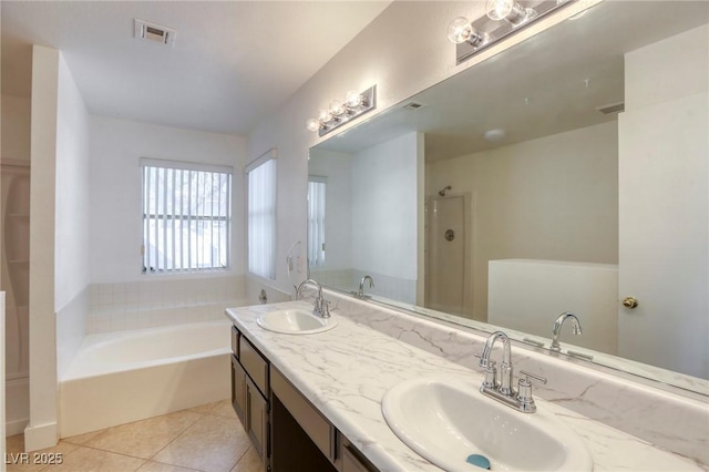 bathroom with tile patterned flooring, separate shower and tub, and vanity