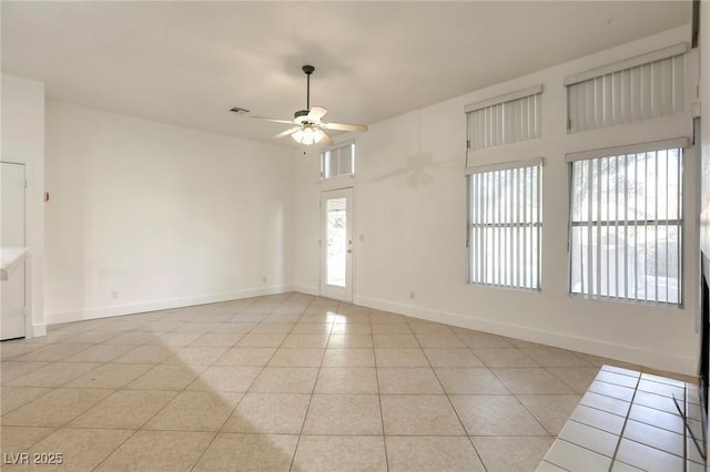 tiled empty room with ceiling fan