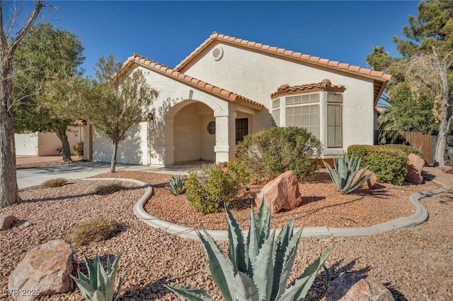 mediterranean / spanish-style home featuring a garage