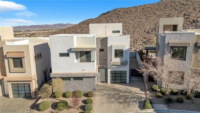 view of front of home with a mountain view and a garage