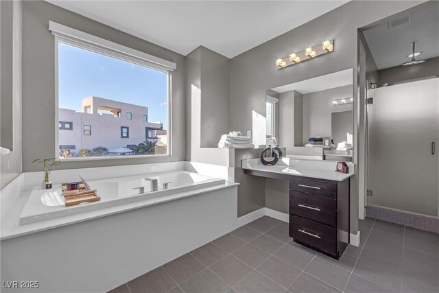 bathroom featuring vanity, tile patterned floors, and a bathing tub