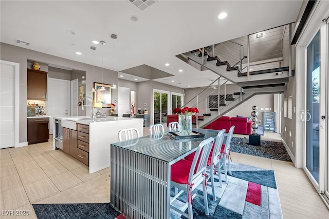 dining space with light tile patterned floors and sink