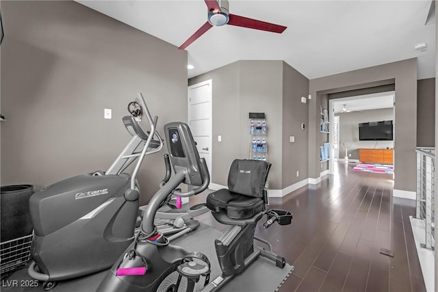 exercise area with ceiling fan and dark wood-type flooring