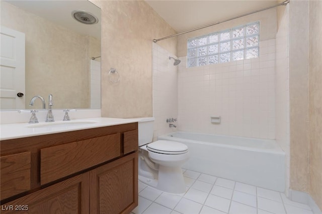 full bathroom featuring toilet, tile patterned flooring, tiled shower / bath combo, and vanity