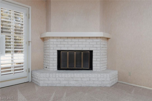 room details featuring a brick fireplace and carpet floors