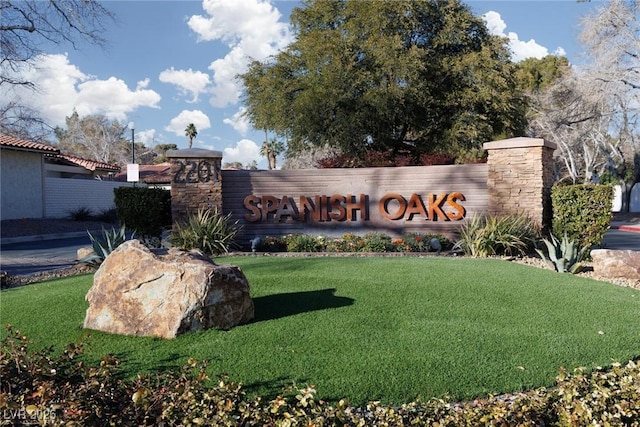 community / neighborhood sign with a lawn