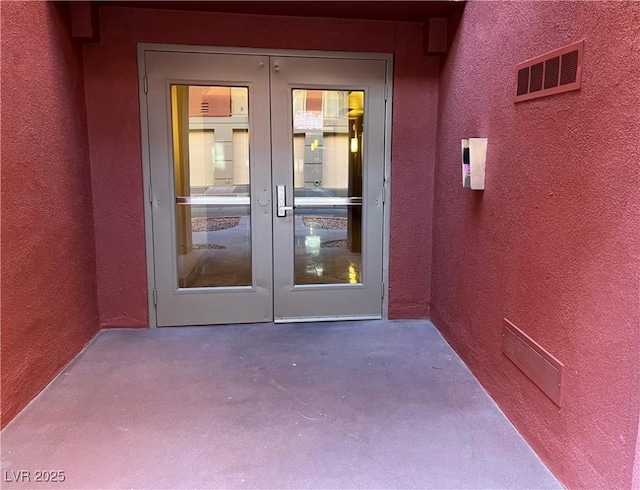 entrance to property with french doors and a patio