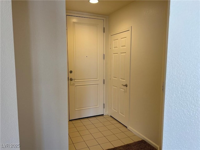 doorway to outside with light tile patterned floors