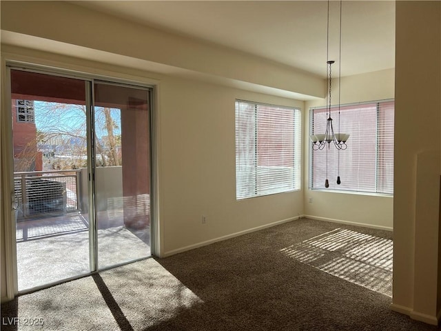 unfurnished dining area featuring a chandelier and dark colored carpet