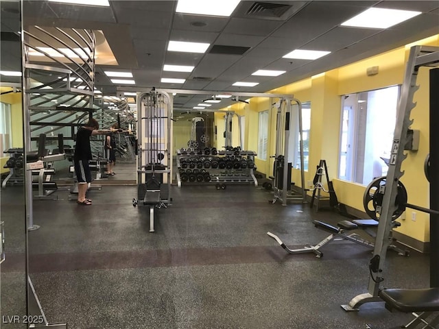 gym with a paneled ceiling