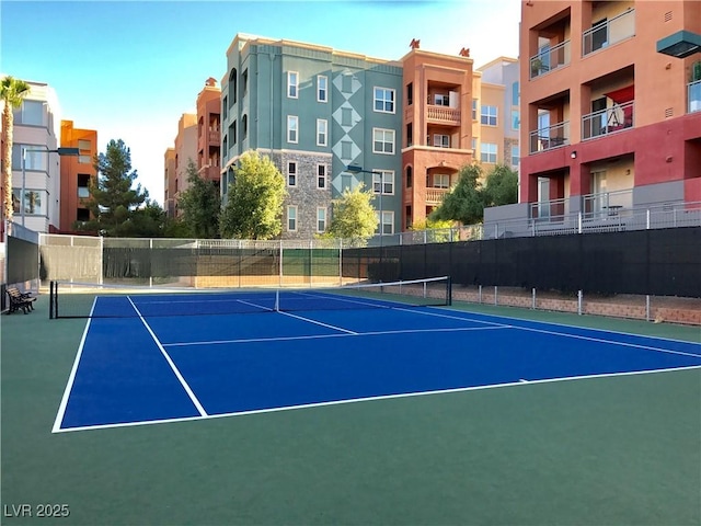 view of tennis court featuring basketball hoop