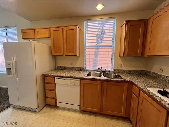 kitchen featuring sink, white appliances, and a wealth of natural light