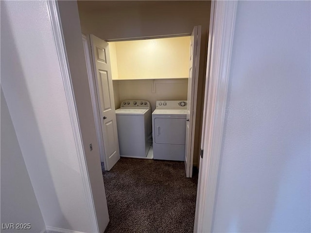 clothes washing area with washing machine and clothes dryer and dark colored carpet