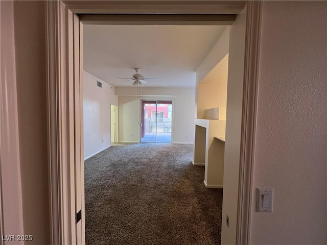 interior space featuring carpet floors and ceiling fan