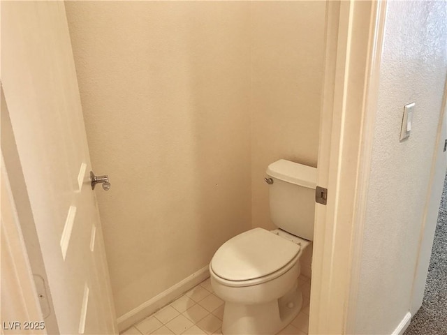 bathroom featuring toilet and tile patterned floors