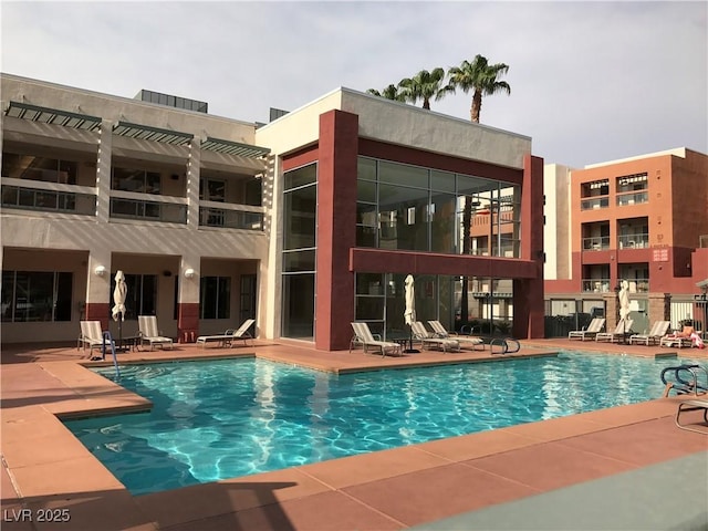 view of swimming pool featuring a pergola and a patio