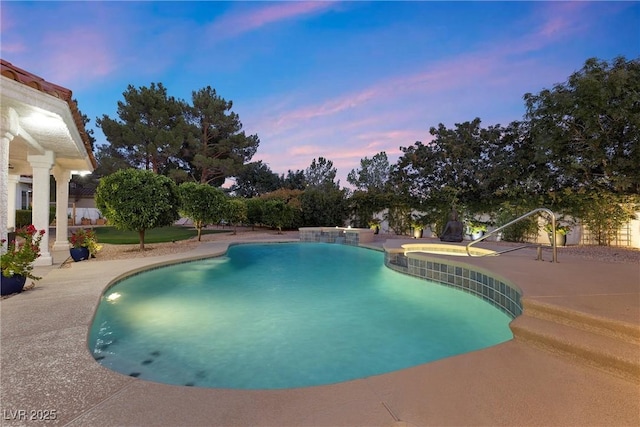 pool at dusk with a patio