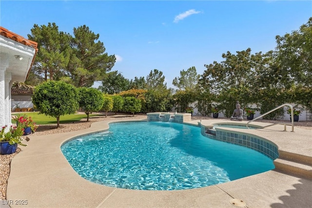 view of swimming pool with pool water feature, a patio area, and an in ground hot tub