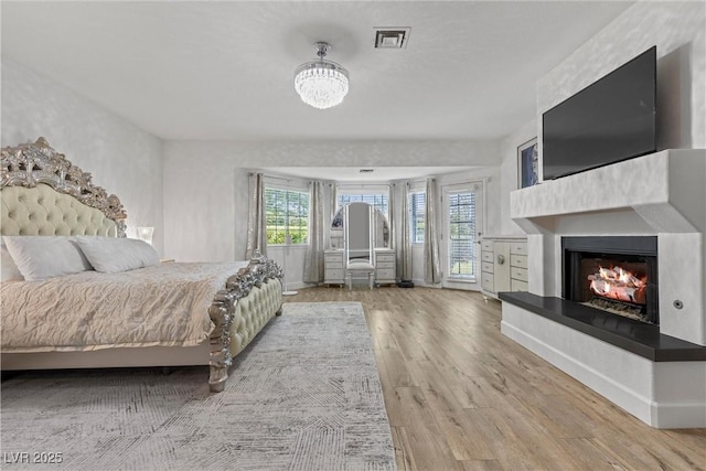 unfurnished bedroom with wood-type flooring and multiple windows