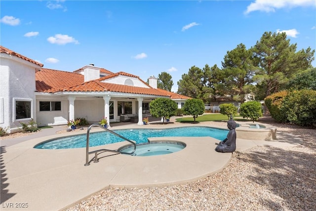 view of pool featuring an outdoor living space, a patio area, and an in ground hot tub