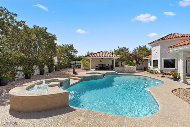 view of pool with an in ground hot tub, a gazebo, pool water feature, and a patio