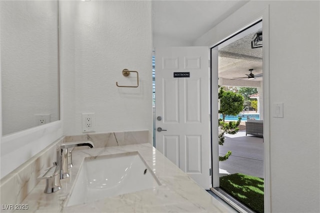 bathroom featuring ceiling fan and vanity