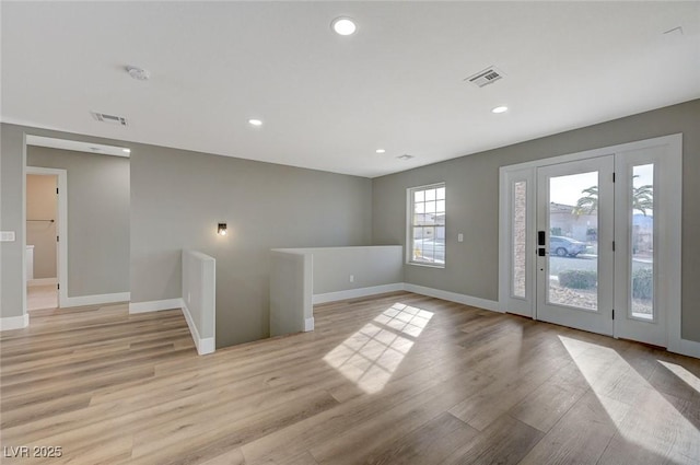 spare room featuring light hardwood / wood-style flooring