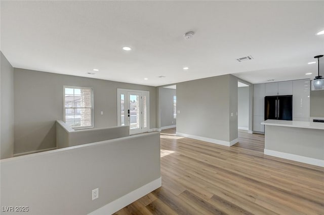 empty room with light hardwood / wood-style flooring