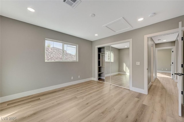 unfurnished bedroom with a closet and light hardwood / wood-style flooring