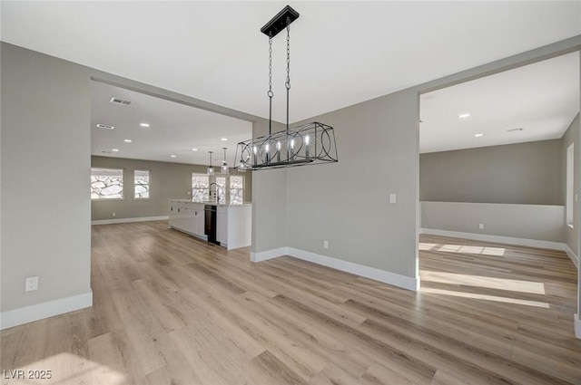 unfurnished dining area with light wood-type flooring