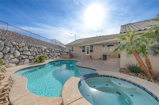 view of swimming pool with an in ground hot tub and a patio area