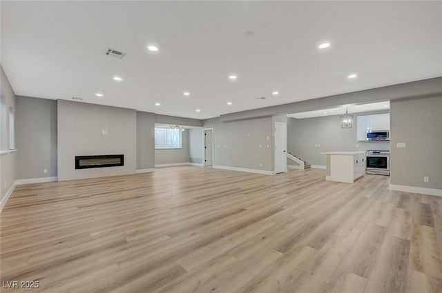 unfurnished living room with light hardwood / wood-style flooring