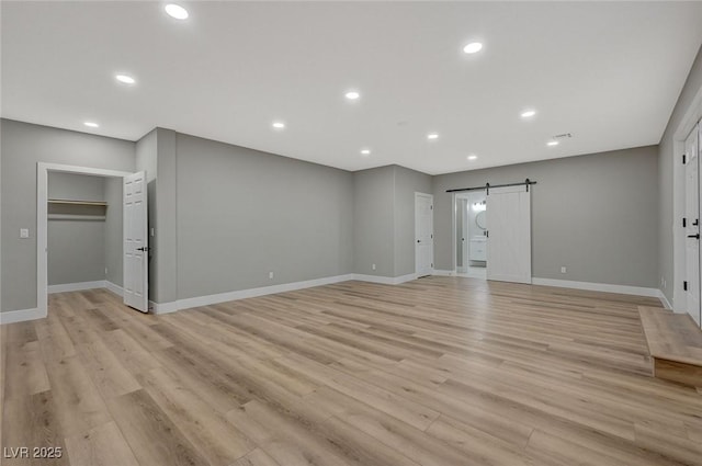 interior space featuring a barn door and light wood-type flooring