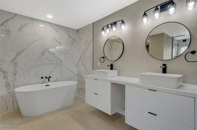 bathroom with a washtub and vanity