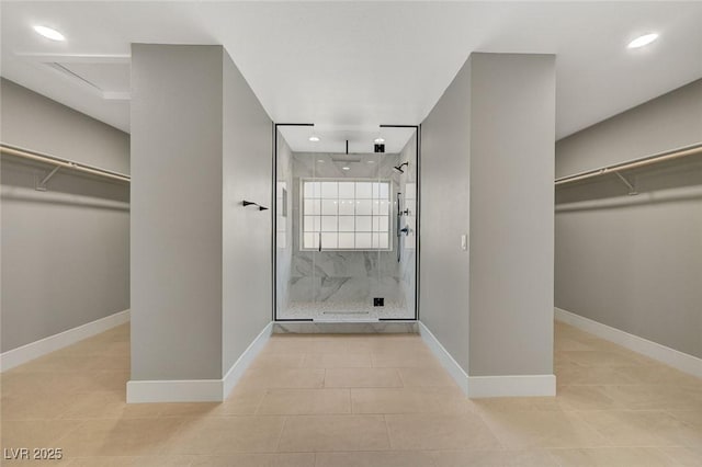 bathroom featuring tile patterned flooring and a tile shower