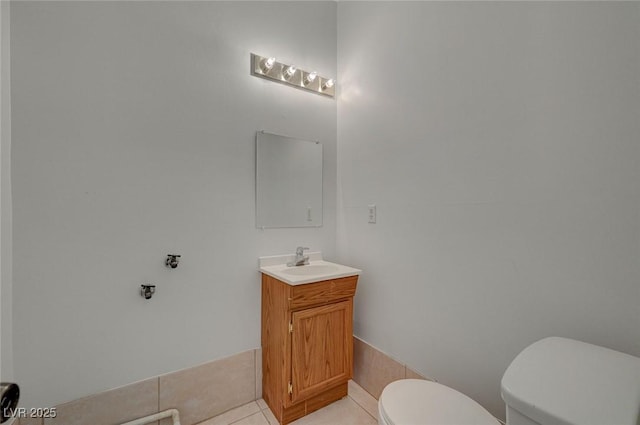 bathroom featuring toilet, tile patterned floors, and vanity