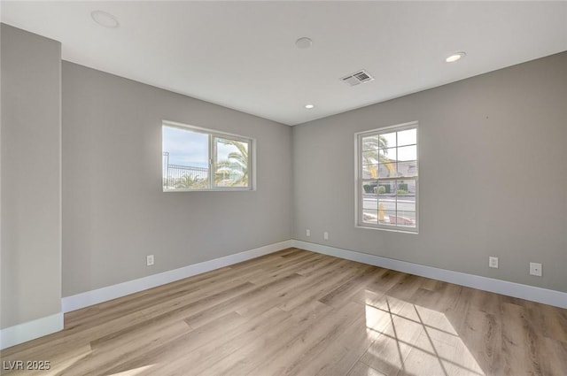 empty room featuring light hardwood / wood-style floors and a healthy amount of sunlight