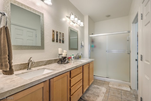 bathroom featuring vanity, tile patterned flooring, and an enclosed shower