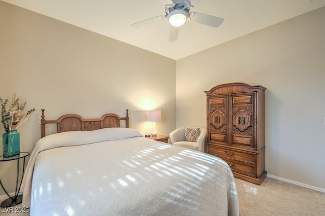 bedroom with ceiling fan and light colored carpet