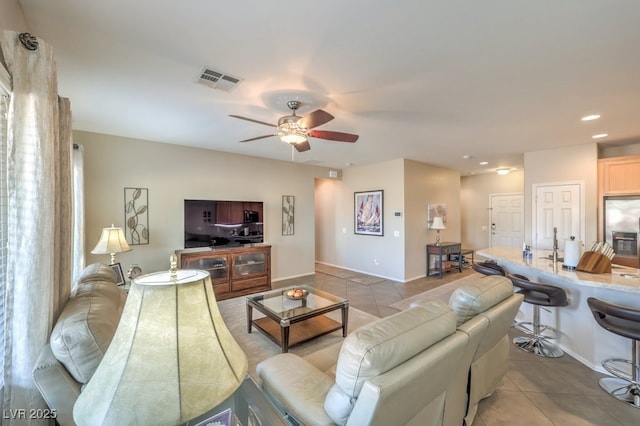 tiled living room featuring ceiling fan