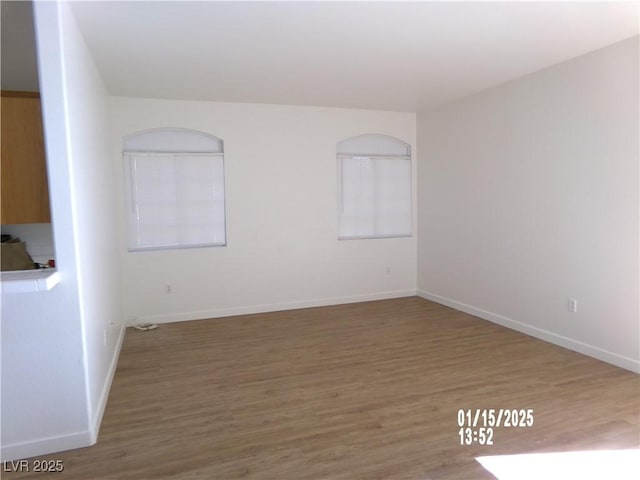 unfurnished room with wood-type flooring