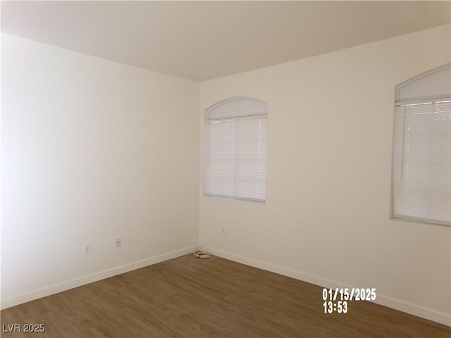 unfurnished room featuring dark wood-type flooring