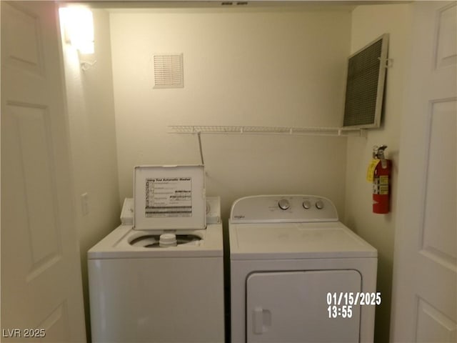 washroom with independent washer and dryer