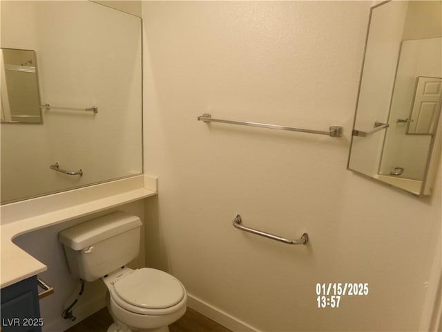 bathroom featuring toilet and vanity