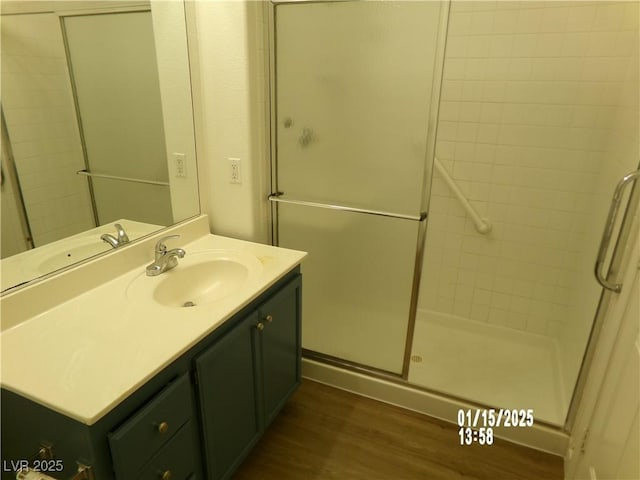 bathroom with vanity, hardwood / wood-style floors, and an enclosed shower