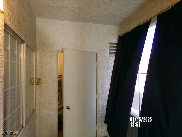 interior space with a textured ceiling